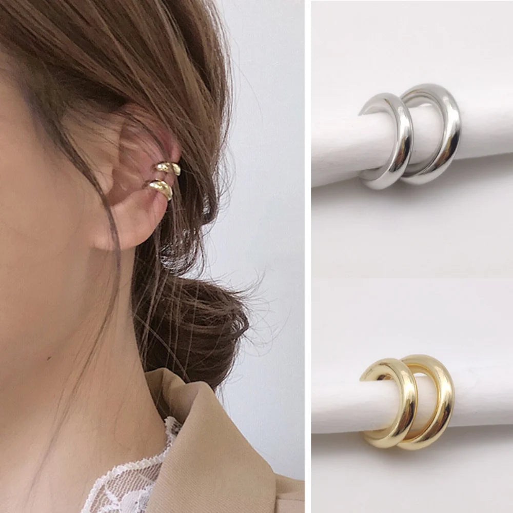 Add a touch of modern elegance with these minimalist gold ear cuffs. Designed in a sleek C-shape geometric style, they clip comfortably onto the ear—no piercing needed.