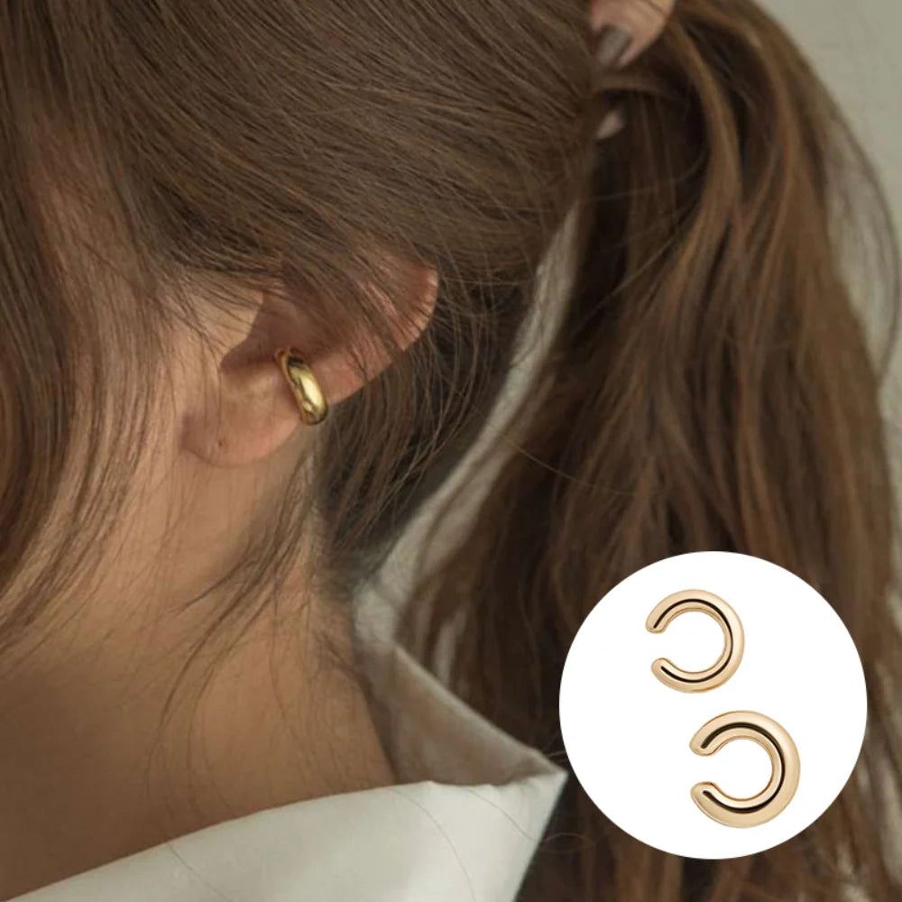 Add a touch of modern elegance with these minimalist gold ear cuffs. Designed in a sleek C-shape geometric style, they clip comfortably onto the ear—no piercing needed.