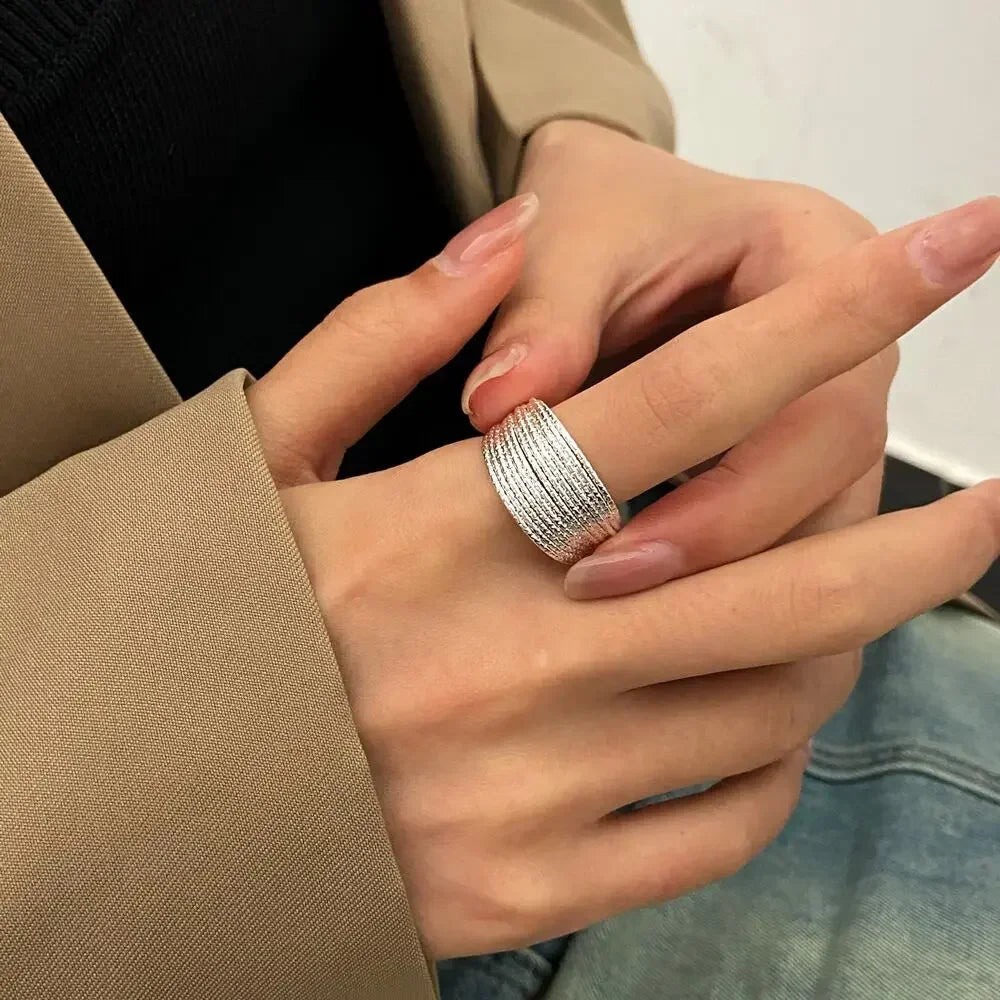Elevate your everyday look with this modern minimalist ring featuring elegant multi-layer line detailing. Crafted in a sleek silver finish, this versatile piece adds a touch of sophistication to any outfit.